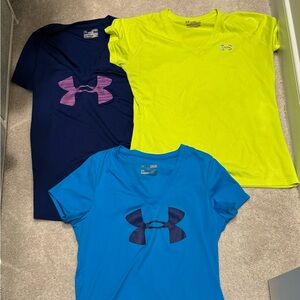 Three women’s Under Armour workout shirts